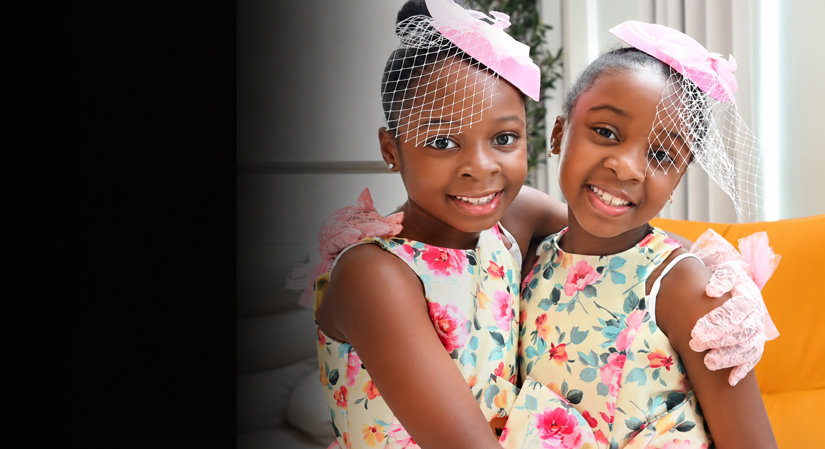Two smiling girls in floral dresses